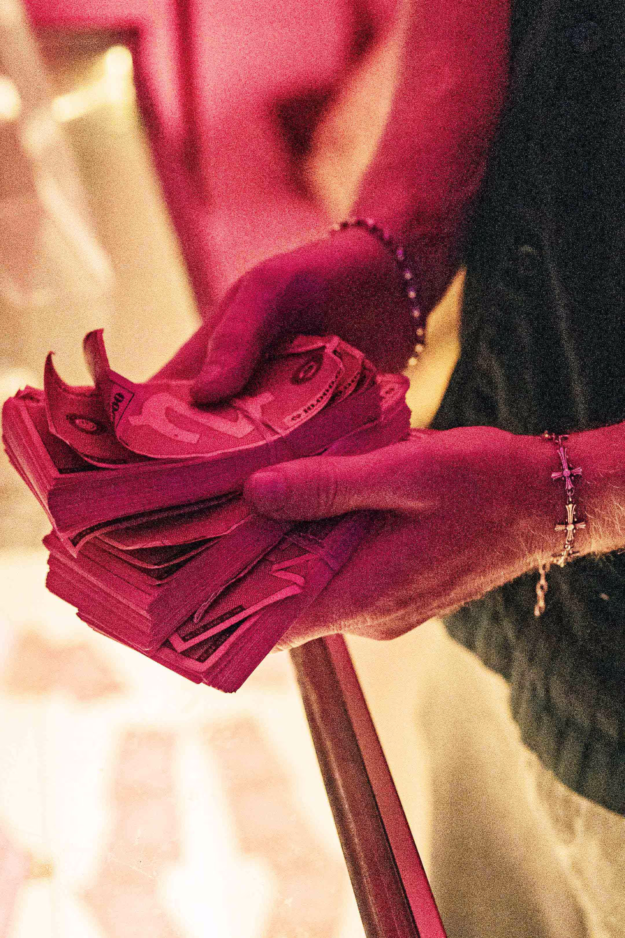 A woman is holding a bunch of pink money