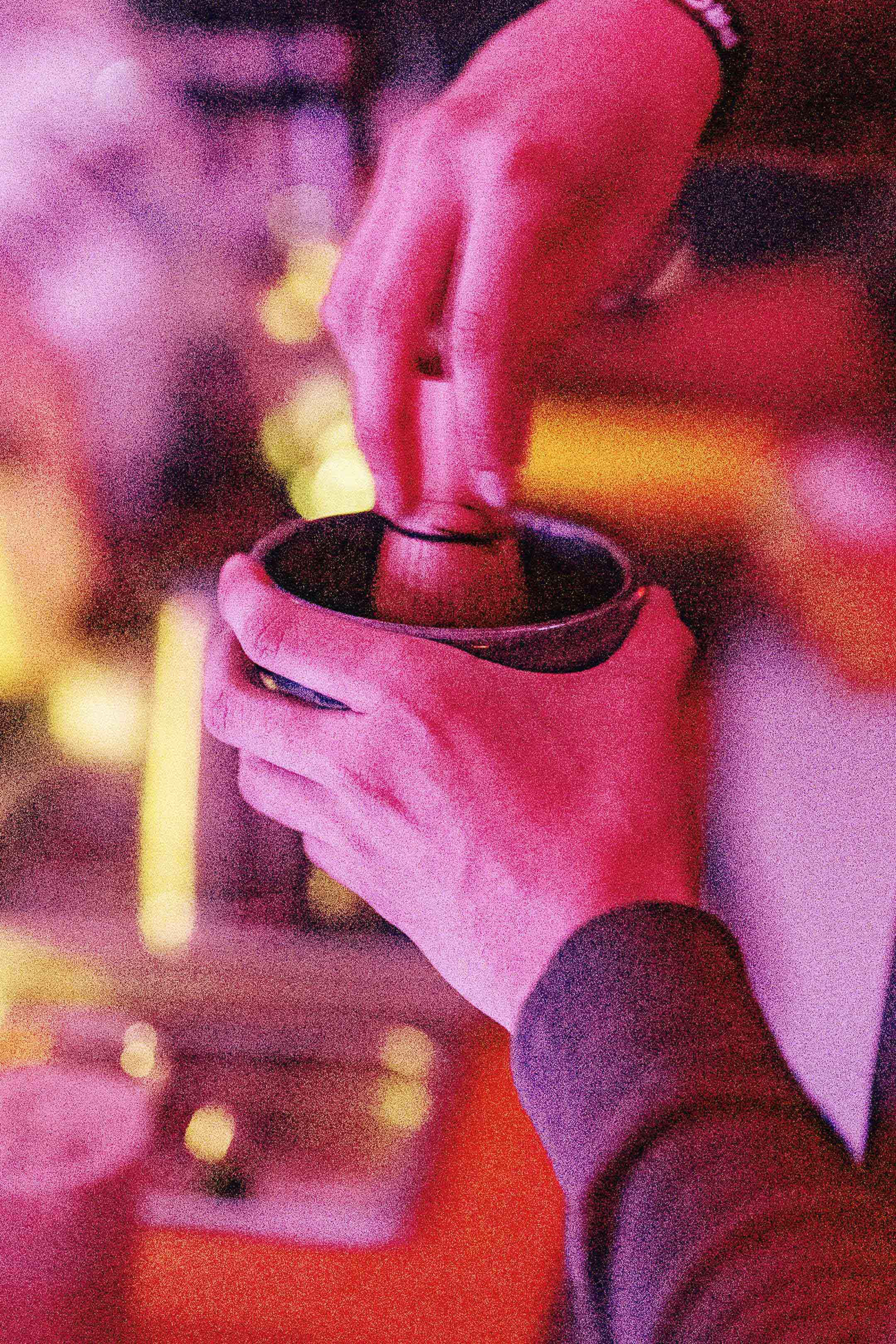 A person holding a cup in their hand.
