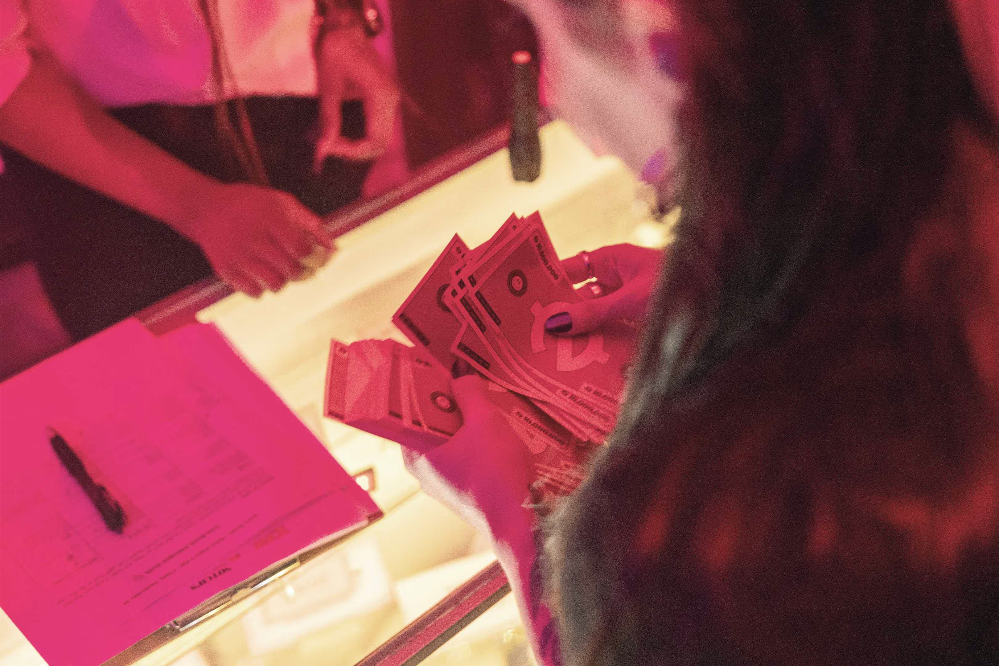 A woman holding a bunch of money in front of a mirror.