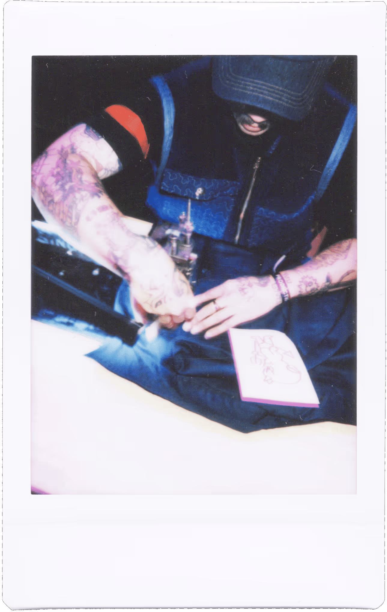 A man with tattoos on his arm and arm.