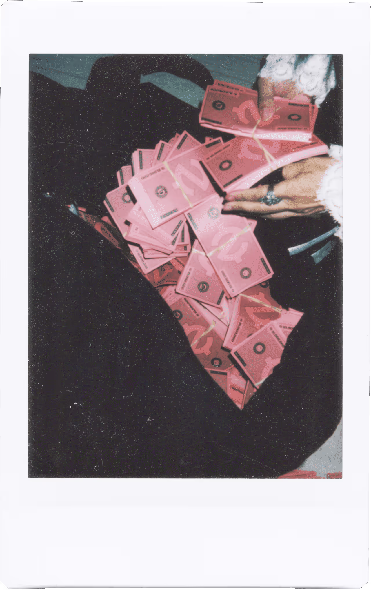 A person holding a bunch of pink money.