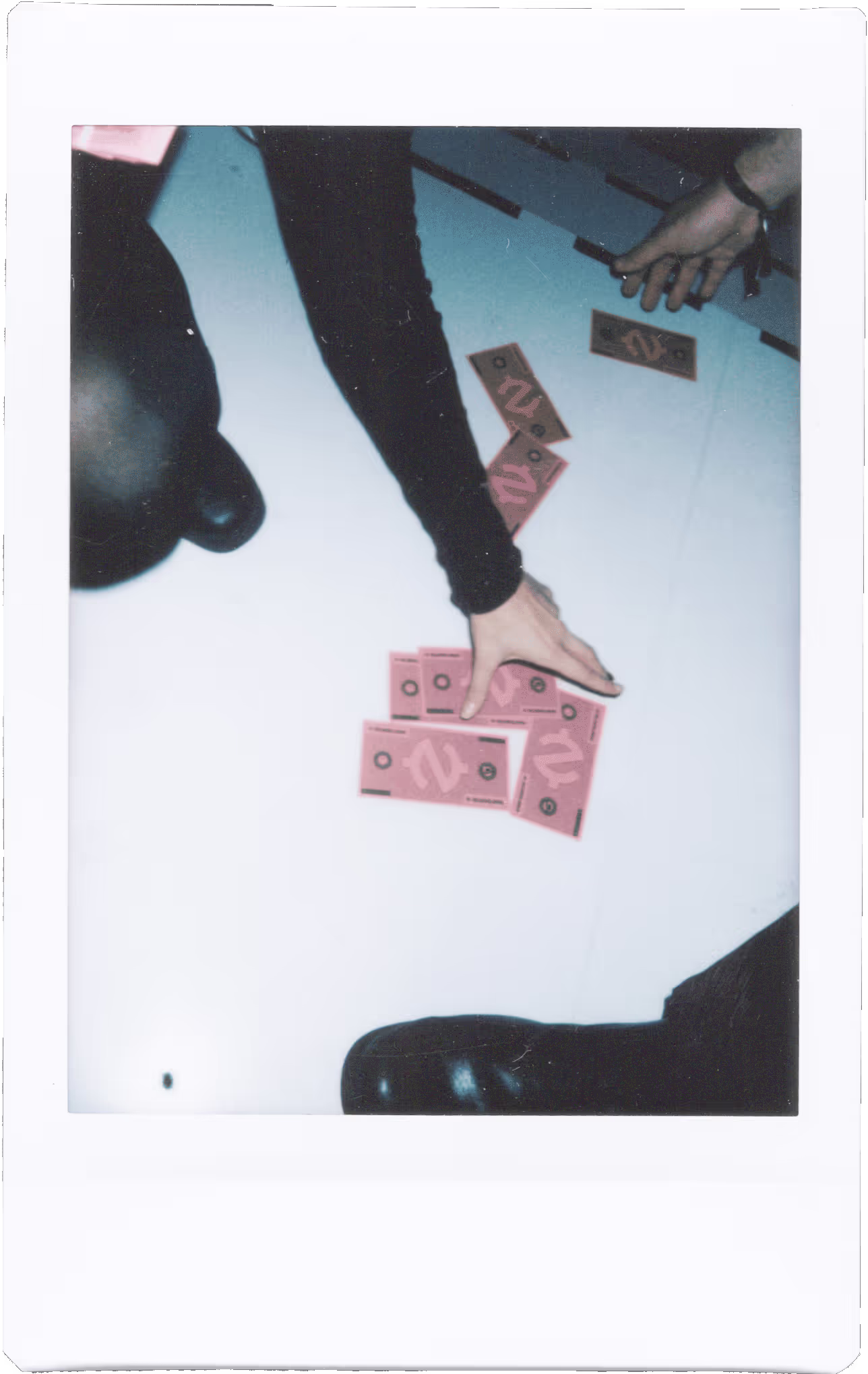 A group of people standing around playing dominos.