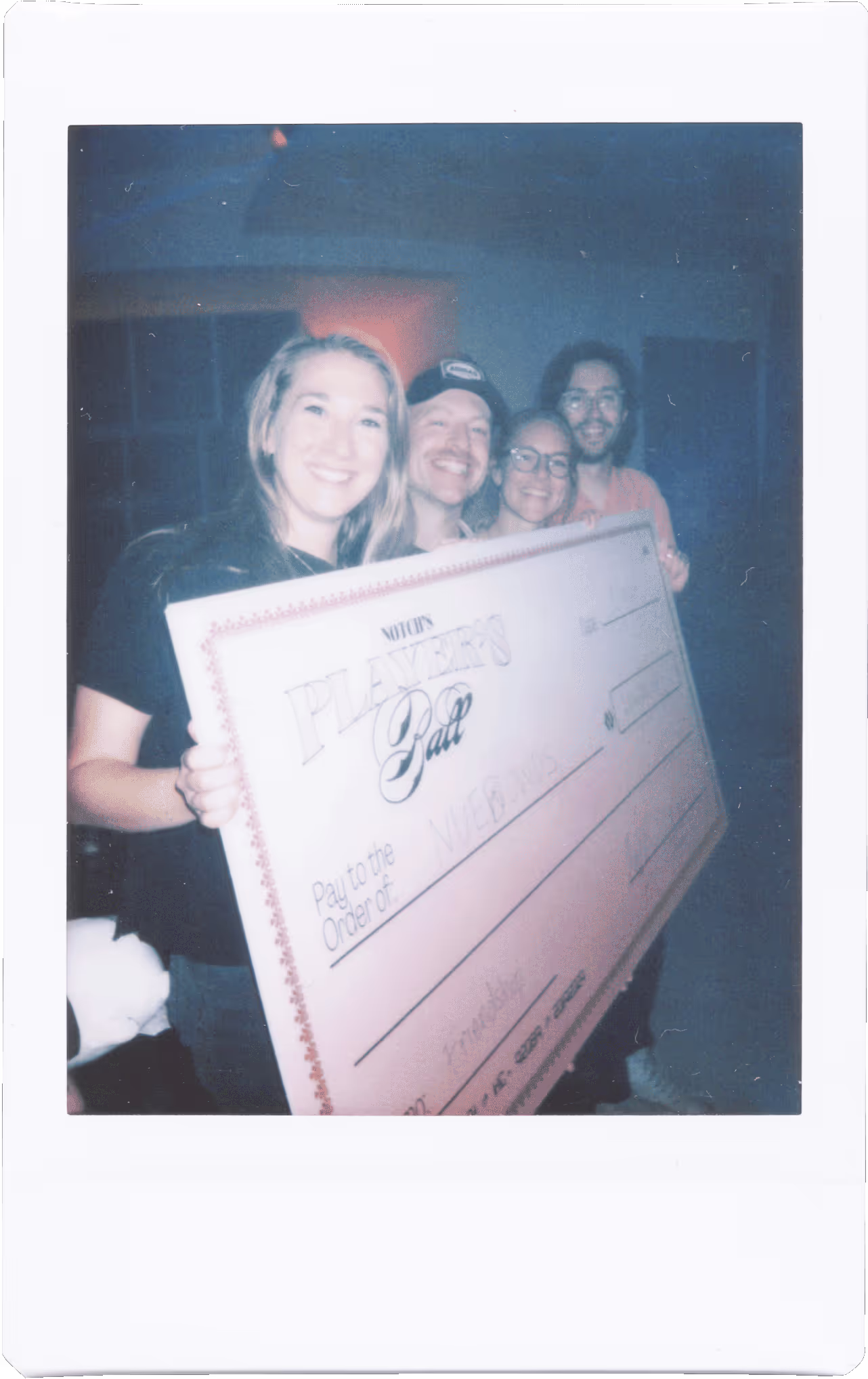A group of people holding a large check.