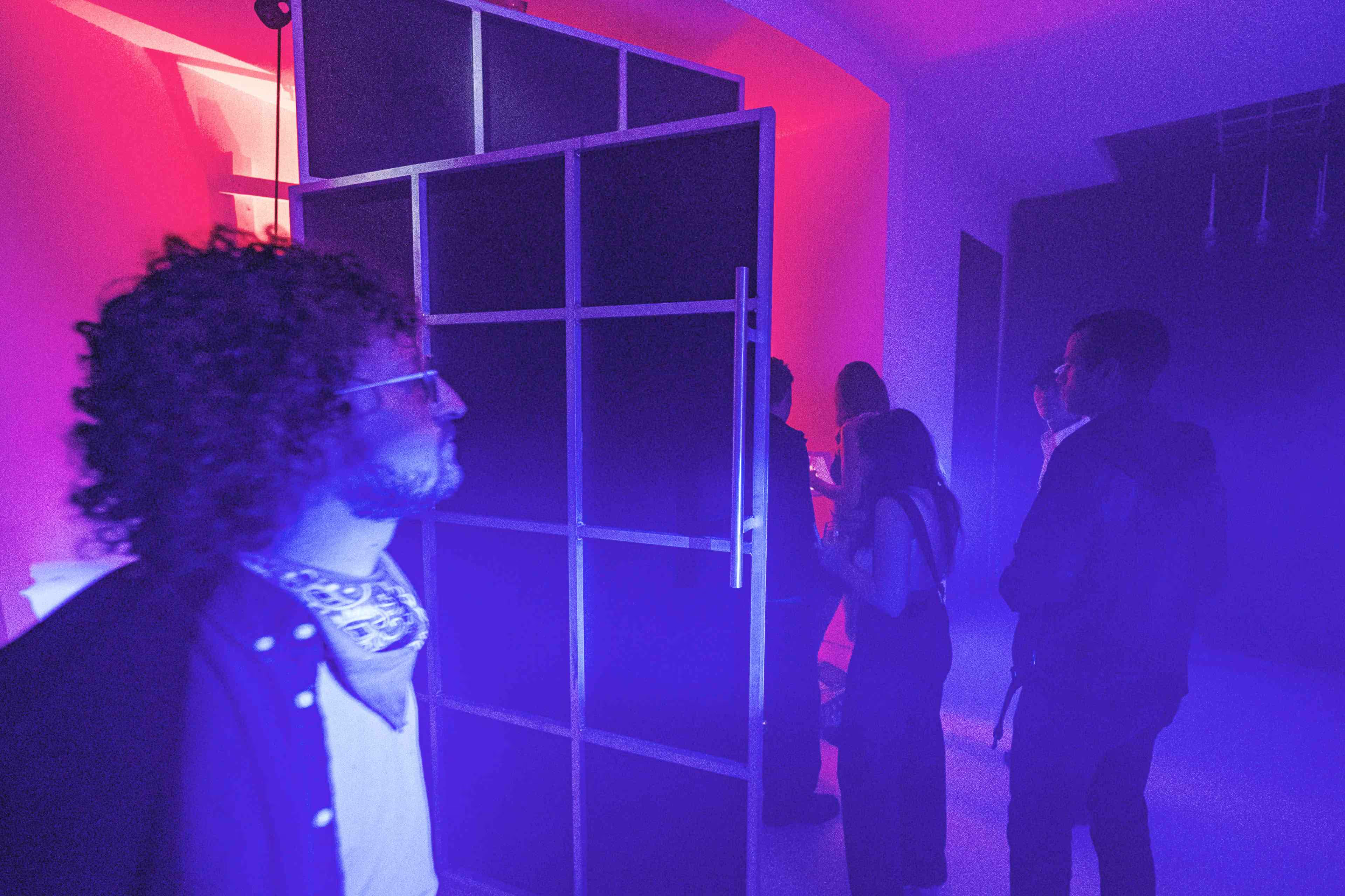 A group of people standing around in a room.