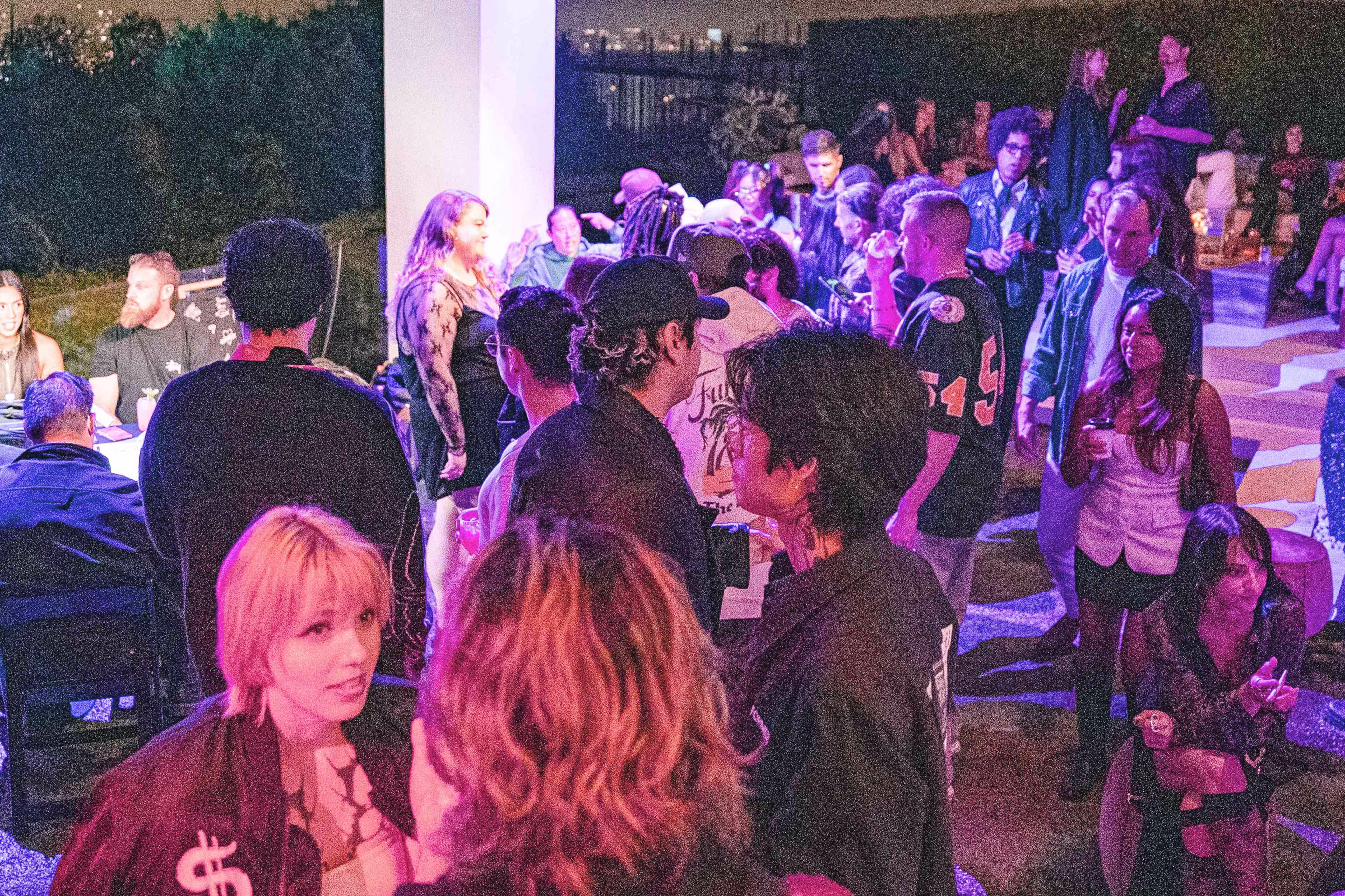 A group of people standing around each other.