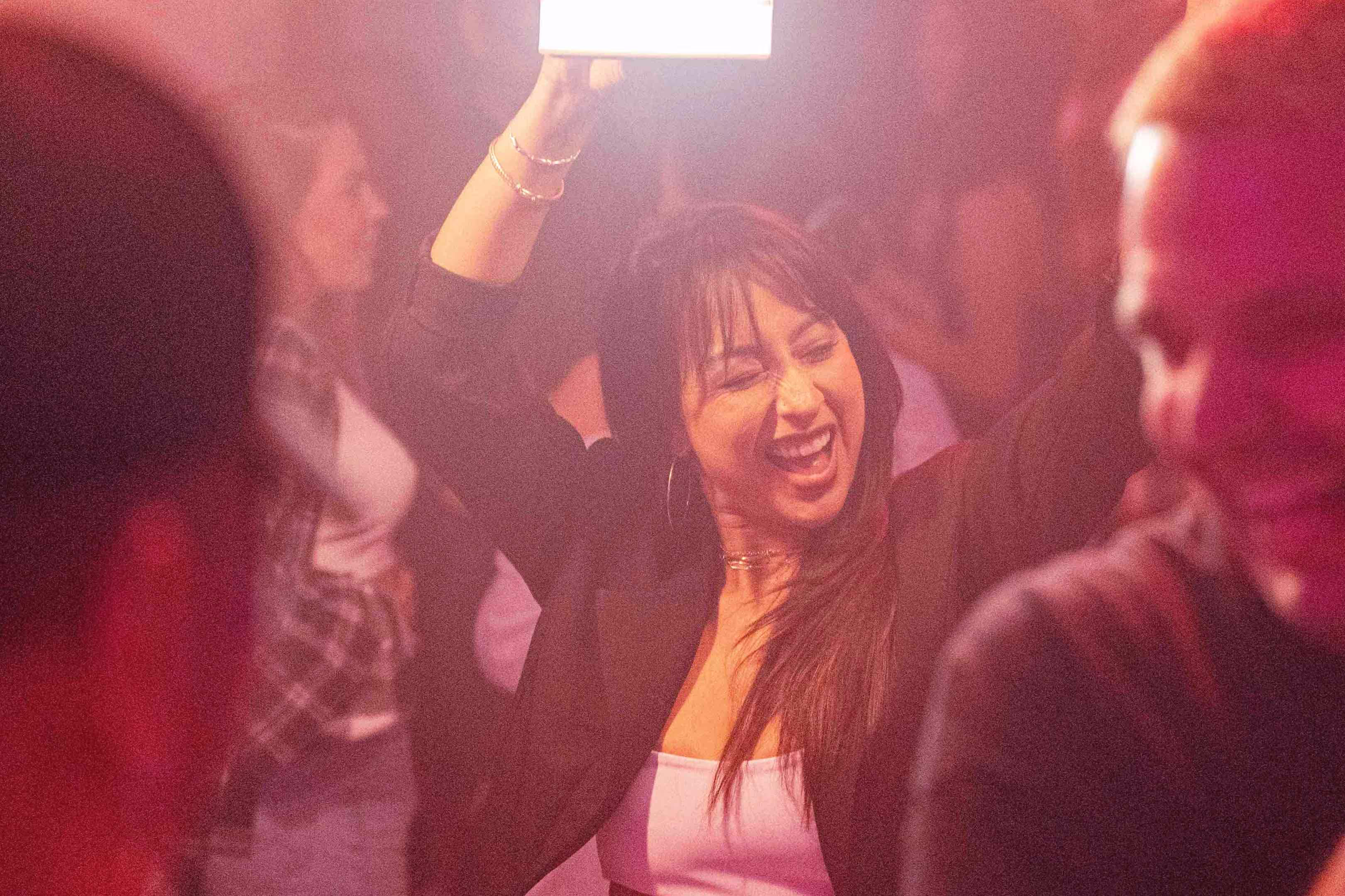 A woman holding a cell phone up to her face.