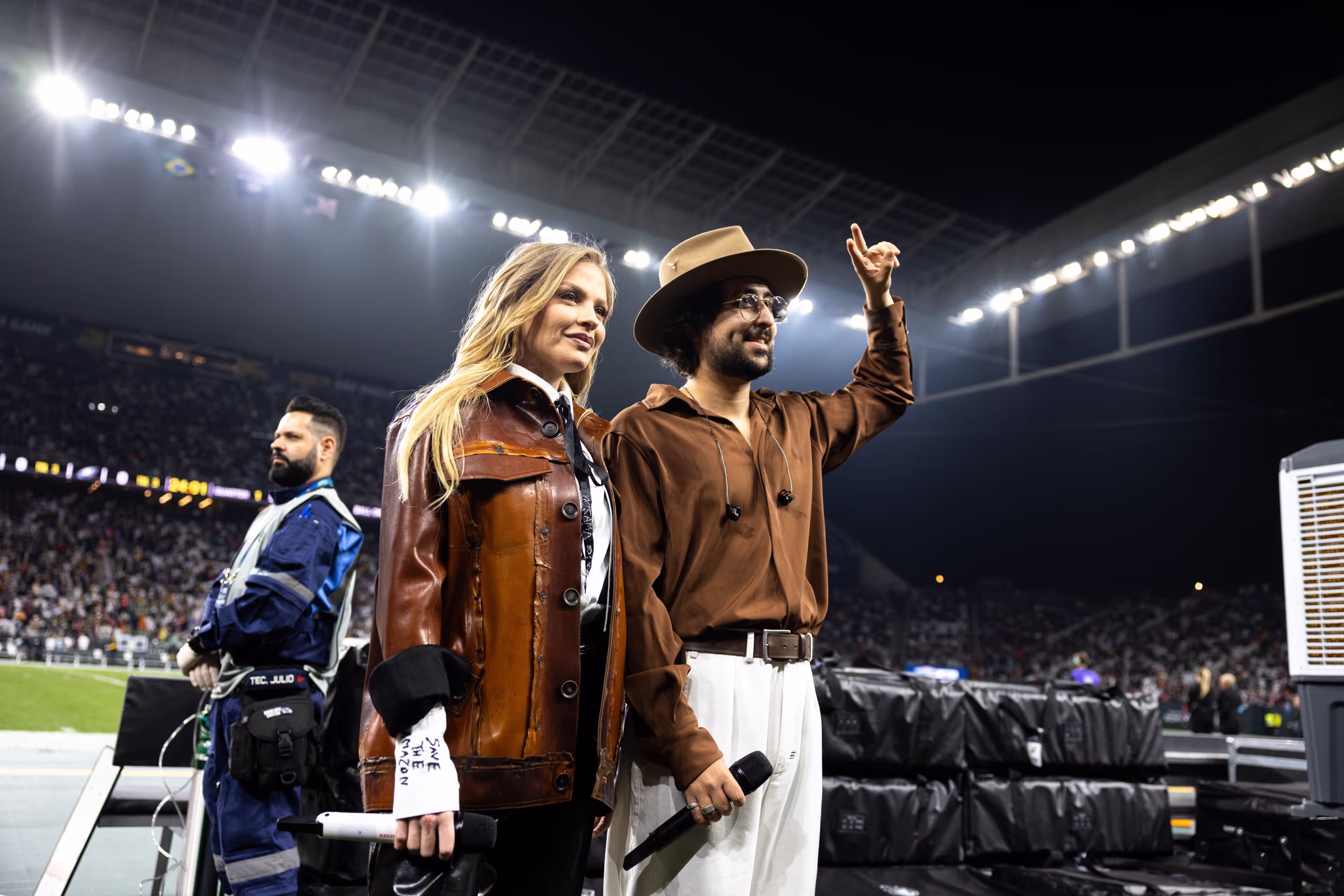 A man and a woman standing on a soccer field.