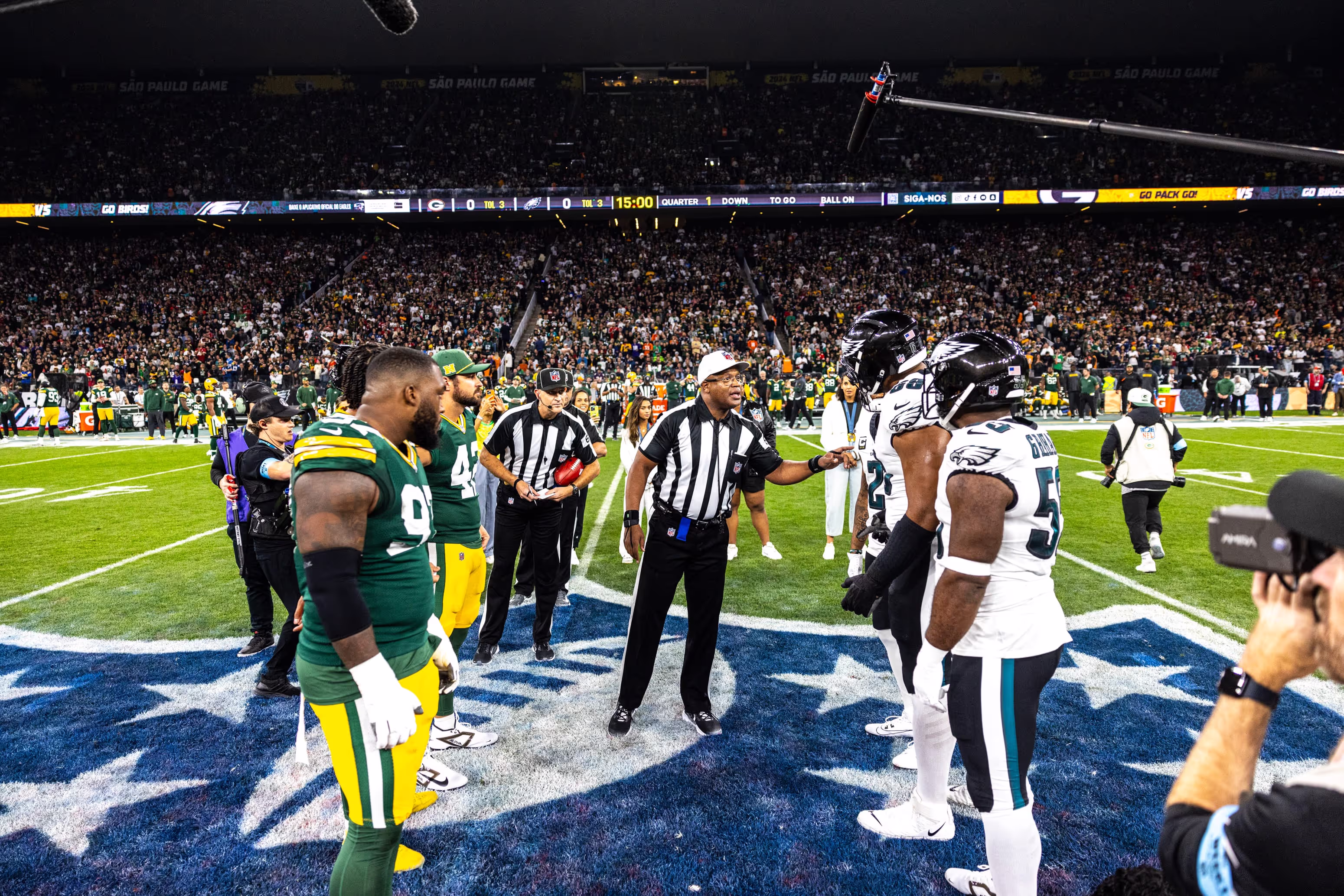 A group of football players standing on top of a field.