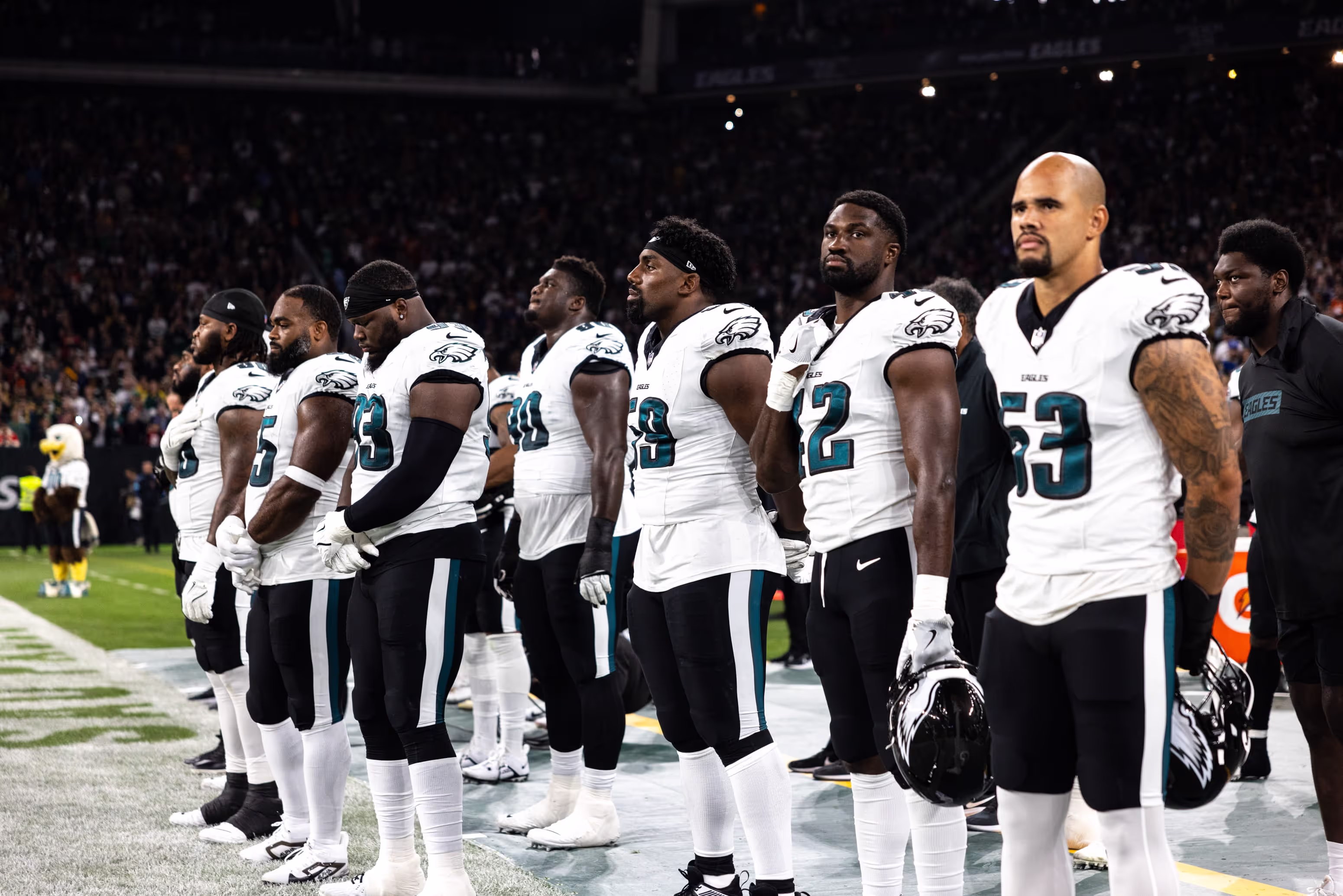 A group of men standing on top of a field.