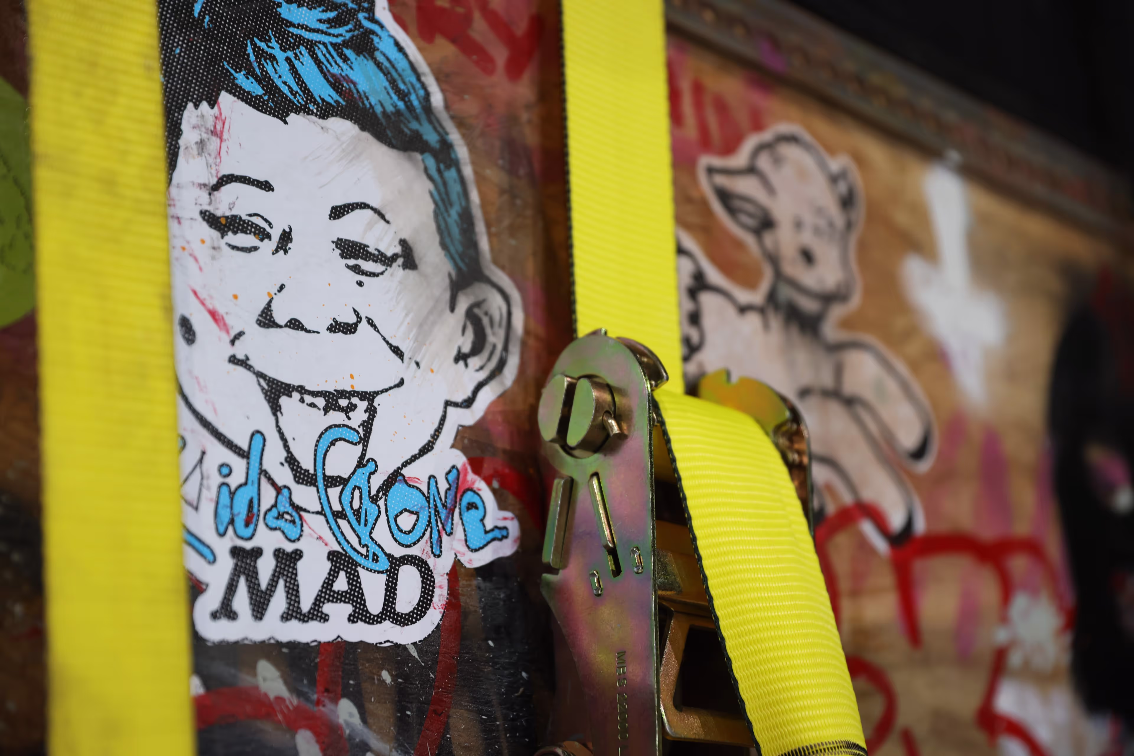 A close up of a wall with graffiti on it.