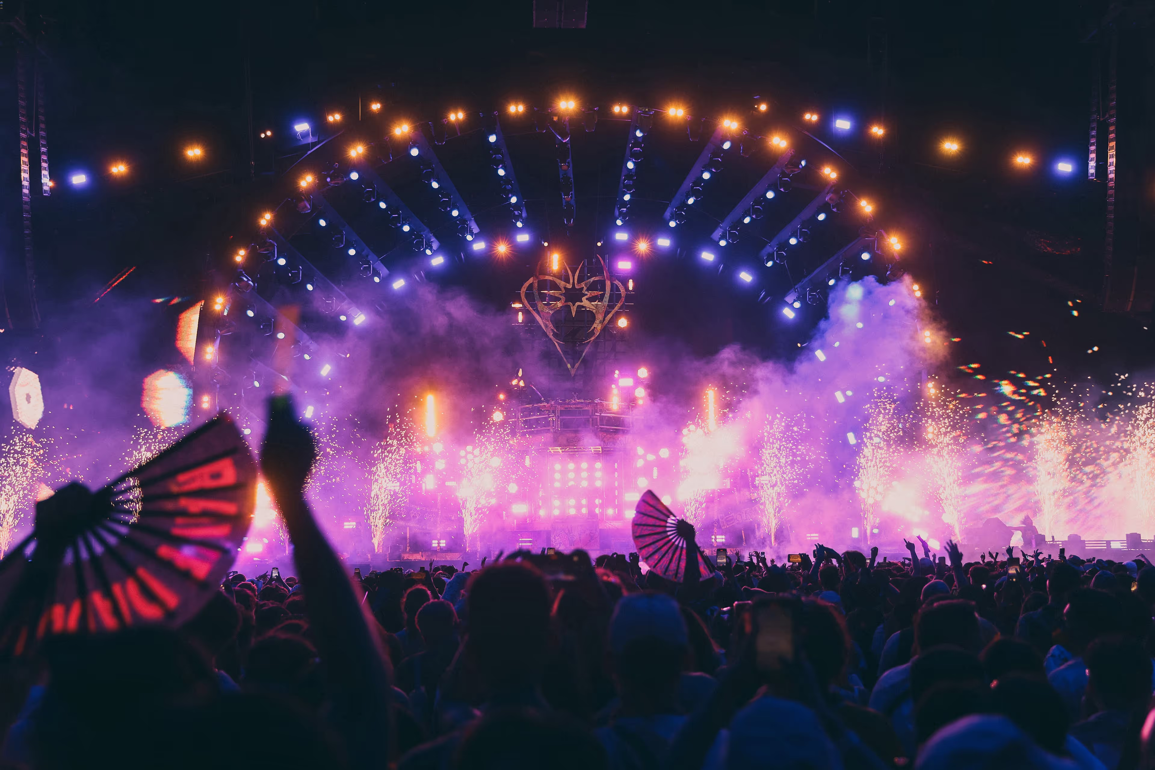 A crowd of people standing around a stage.