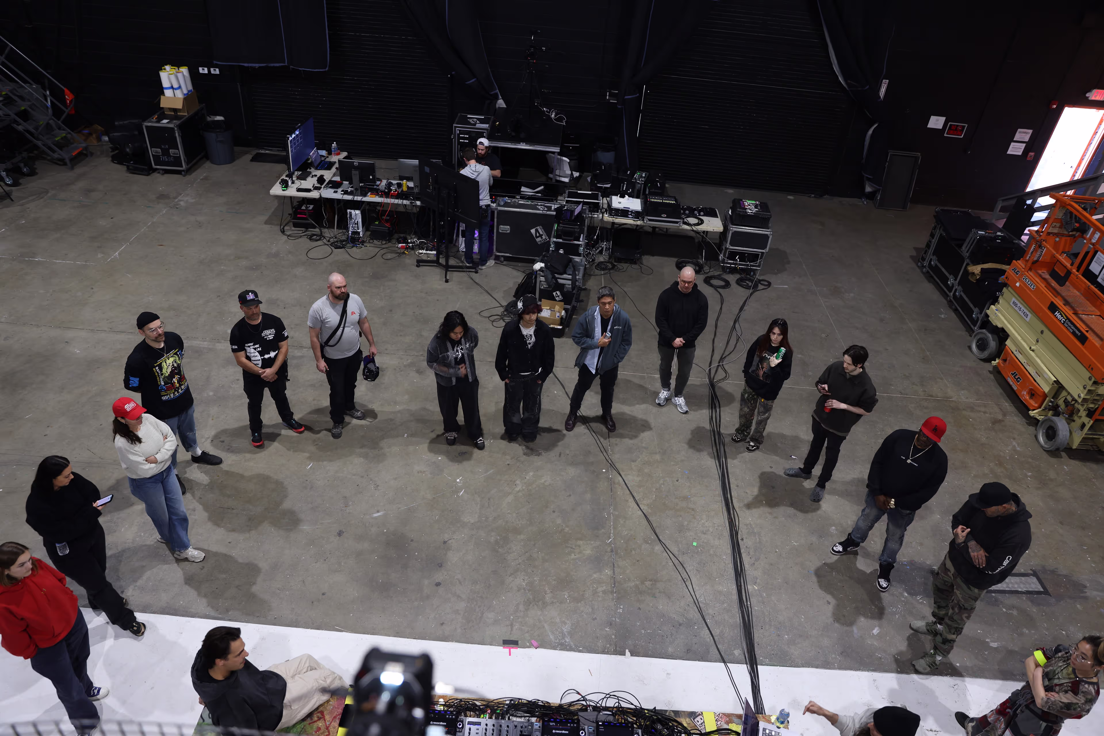 A group of people standing around in a room.
