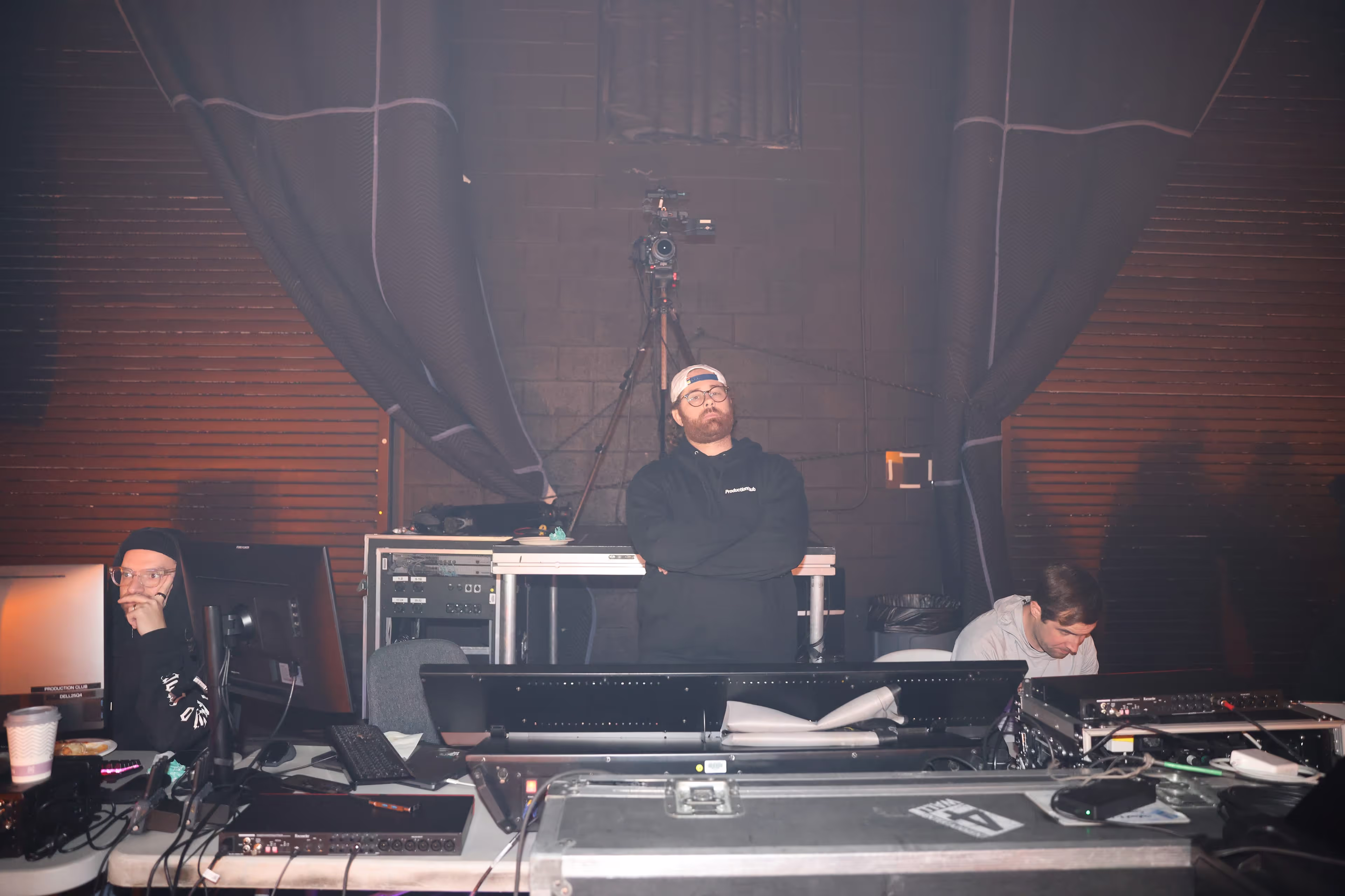 A man standing in front of a DJ set.