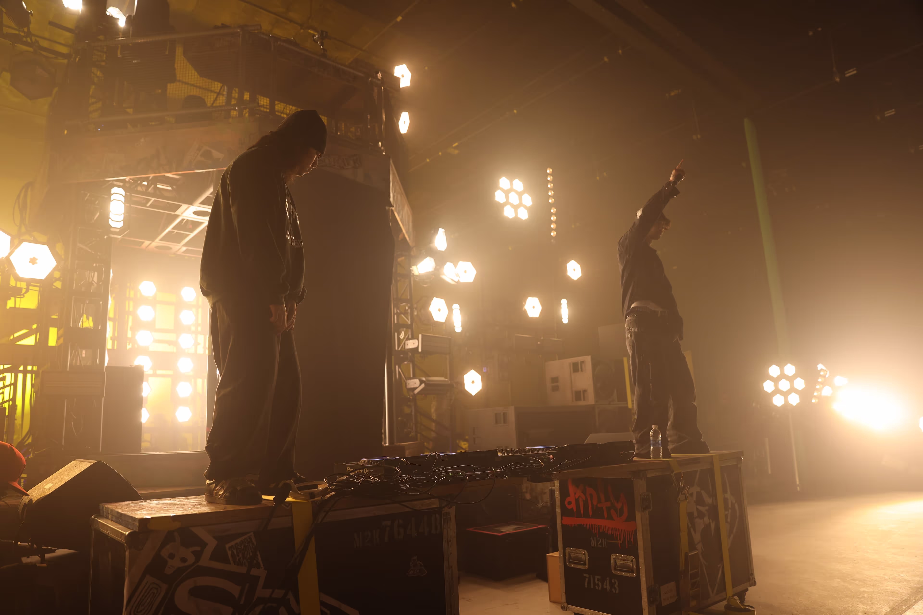 A couple of people standing on top of a stage.