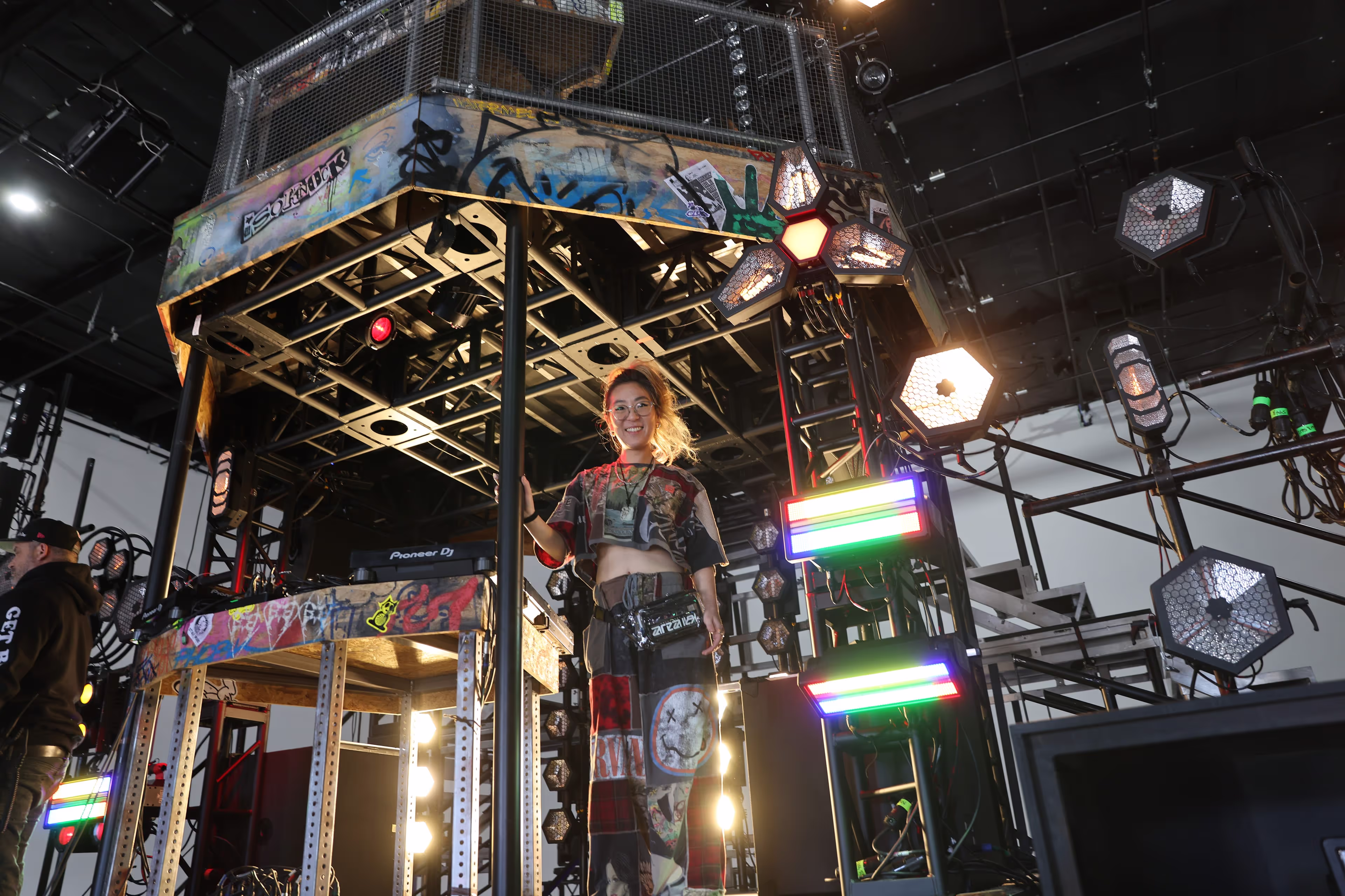 A person standing on a stage with a microphone.
