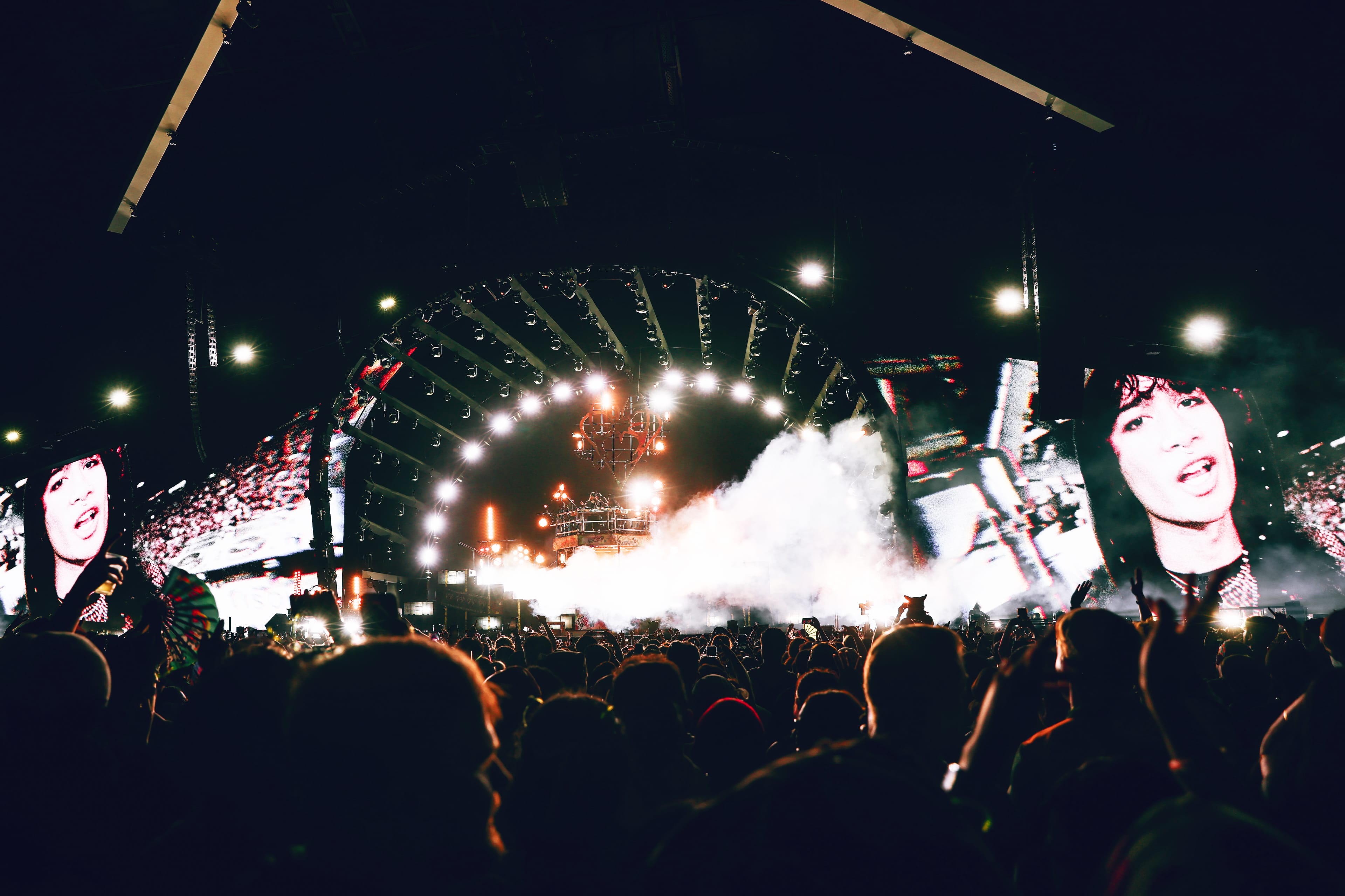 Crowd watching a nighttime outdoor concert.